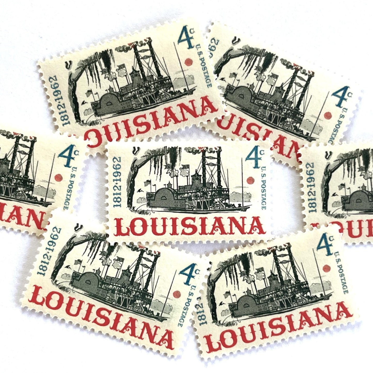 Image of Louisiana Statehood postage stamps from 1962, featuring a Mississippi River steamboat on vintage unused 4-cent USPS postage, Scott 1197.