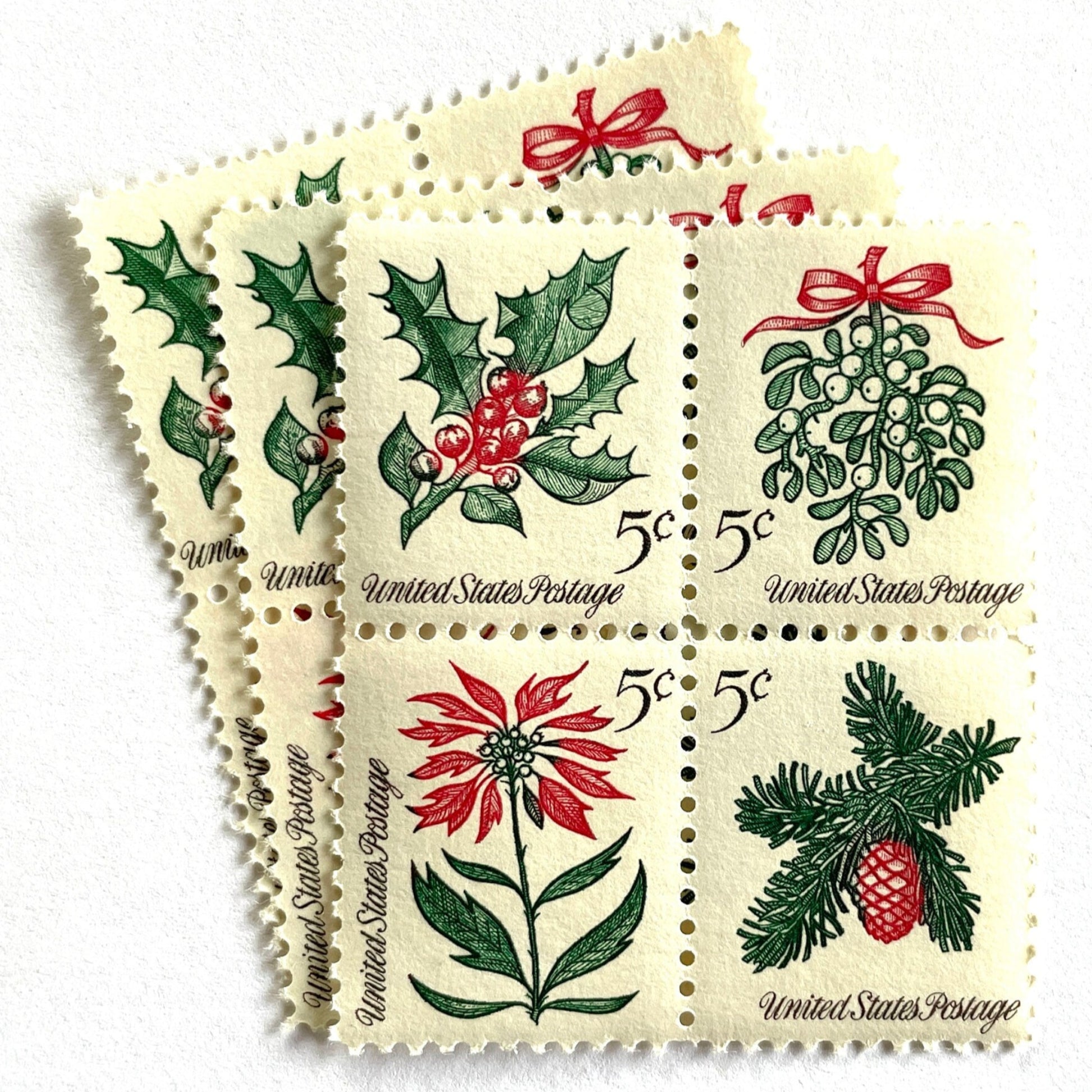 Image of four 5-cent “Christmas Issue Se-Tenant” USPS postage stamps featuring green and red holiday plants from the 1964 Contemporary Christmas Series. Mistletoe, Holly, Poinsettia, Evergreen. Scott #1254, Scott #1255, Scott #1256, Scott #1257.