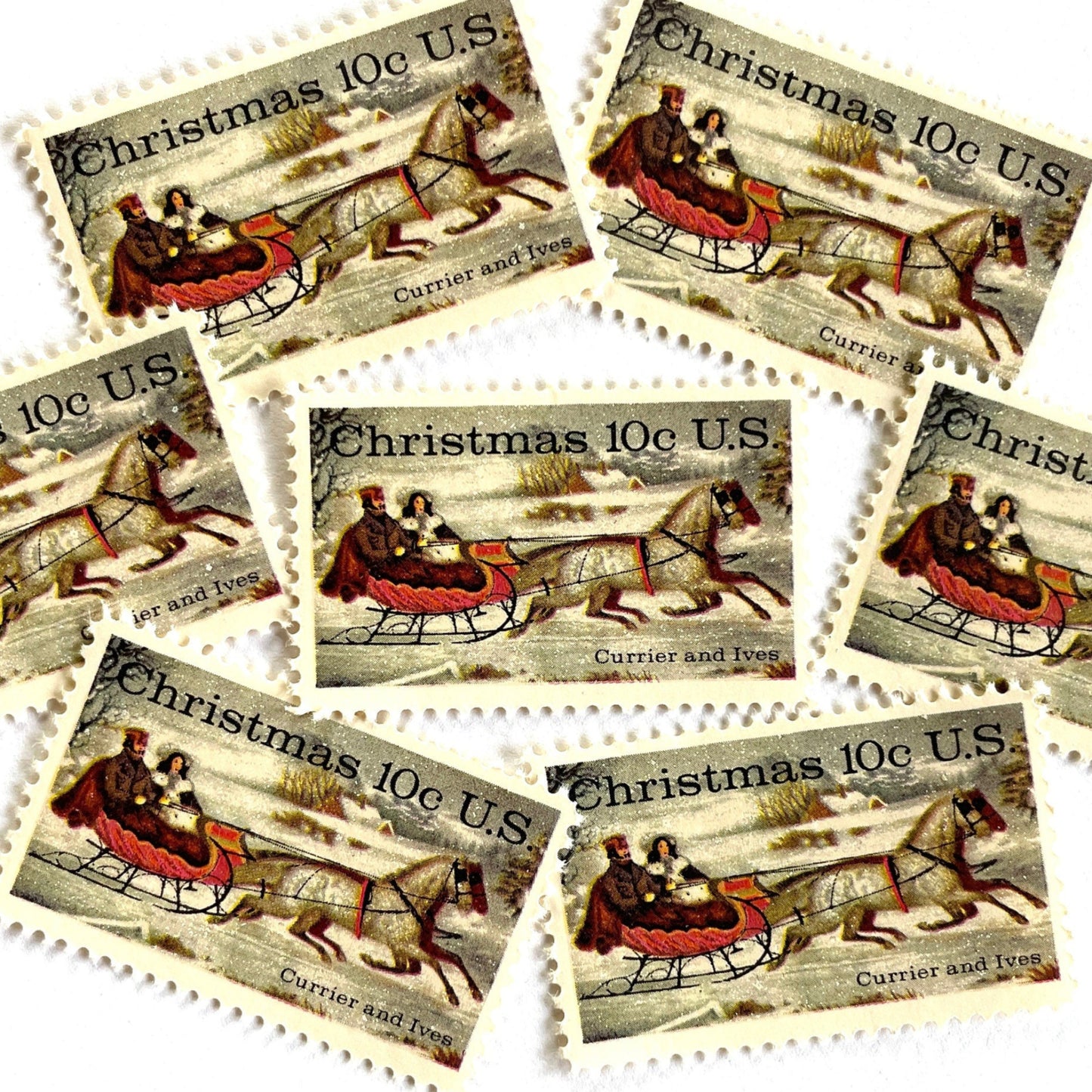Image of 1974 Currier and Ives "Winter Road" 10 cent stamps. Scott #1551. Stamp themes: Christmas, Sleigh, Holidays, Sleigh-ride, Horse-drawn, Snow. White postage stamp.