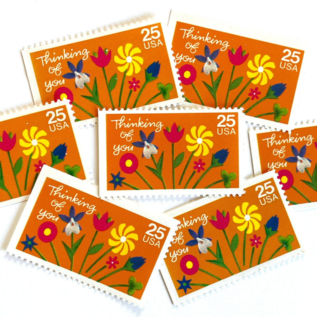 Thinking of You postage stamps from 1988 featuring colorful folk art flowers against a sunny orange background on vintage unused 25-cent USPS postage, Scott 2397.