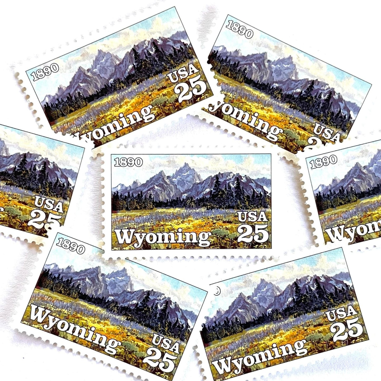 Image of Wyoming Statehood Centennial postage stamps from 1990, featuring the Grand Teton Mountains and wildflower meadow on vintage unused 25-cent USPS postage, Scott 2444.