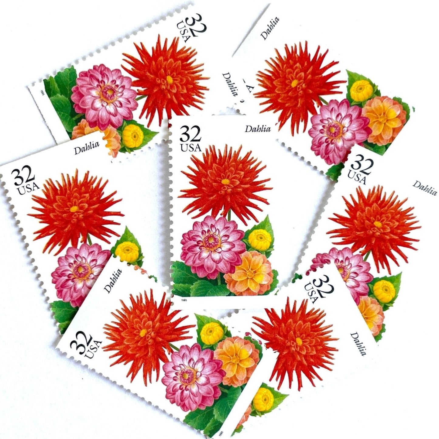 Image of 1995 Garden Flowers series “The Fall Garden: Dahlia” unused 32-cent vintage USPS mail stamps. Scott #2995. Stamp Themes: Flowers, Floral, Botanical, Fragrant, Gardening, Fall, Autumn, Nature, Mexican National Flower. Red, Pink, Yellow, Green, Multicolored gummed postage stamp. Perfect postage stamp to use for save the date announcements, wedding invitation postage, bridal shower invitations, birth announcements, thank you cards, valentine’s day, and snail mail.
