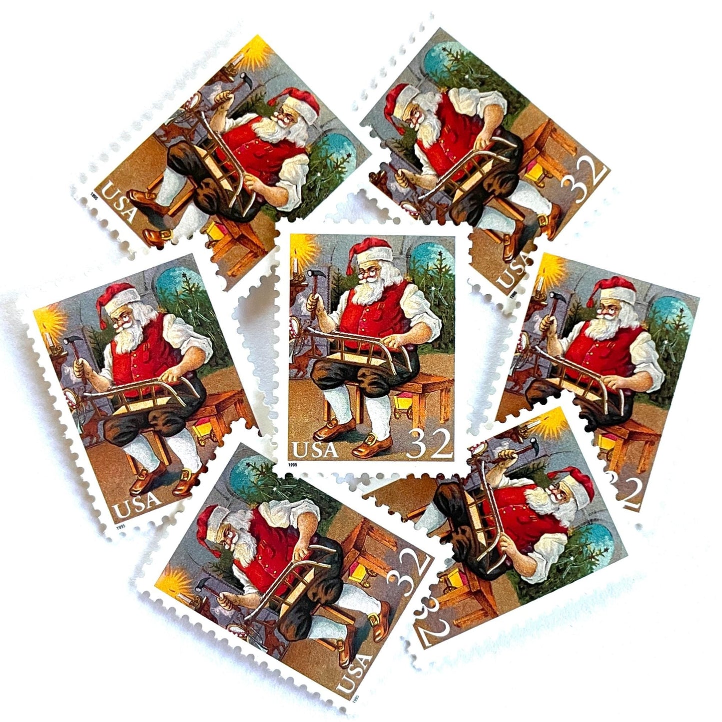 Image of 32-cent Contemporary Christmas 1995 Santa and Children “Santa Building a Sled” USPS postage stamps featuring a classic illustration of Santa Claus at work in his workshop, depicted sitting on a wooden bench, wearing his traditional red suit and hat, with a long white beard and spectacles, building a toy sled. Scott #3007. Stamp themes: Christmas, holidays, winter, toys, gifts, winter wedding, winter save-the-date. Red postage stamp.