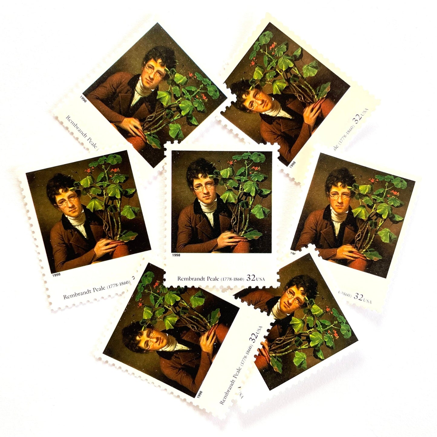 Rembrandt Peale’s "Rubens Peale with a Geranium" Postage Stamp from the 1998 Four Centuries of American Art Series. This stamp depicts a painting the artist’s brother, a botanist, holding a potted plant. An iconic horticultural or gardening theme, this predominately brown postage stamp is often used to mail wedding invitations. These are vintage unused USPS postage stamps with a face value of 32 cents each. Scott number 3236D.