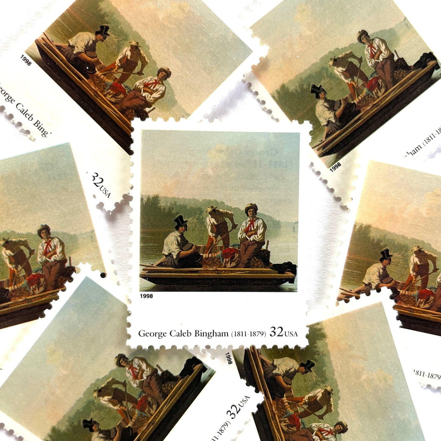 George Caleb Bingham’s “Boatmen on the Missouri" Postage Stamp from the 1998 Four Centuries of American Art Series. This stamp depicts the iconic landscape painting of boatmen navigating the Missouri River. An iconic nature theme, this postage stamp depicts the three med rafting down the Missouri River. These are vintage unused USPS postage stamps with a face value of 32 cents each. Scott number 3236F.