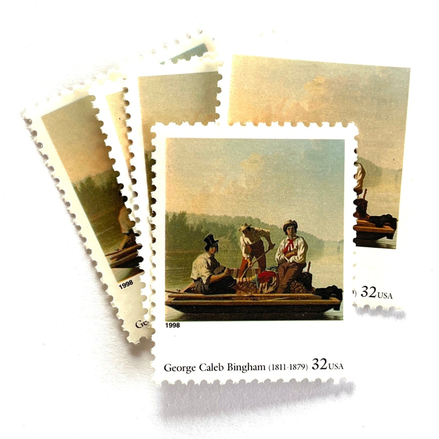 George Caleb Bingham’s “Boatmen on the Missouri" Postage Stamp from the 1998 Four Centuries of American Art Series. This stamp depicts the iconic landscape painting of boatmen navigating the Missouri River. An iconic nature theme, this postage stamp depicts the three med rafting down the Missouri River. These are vintage unused USPS postage stamps with a face value of 32 cents each. Scott number 3236F.