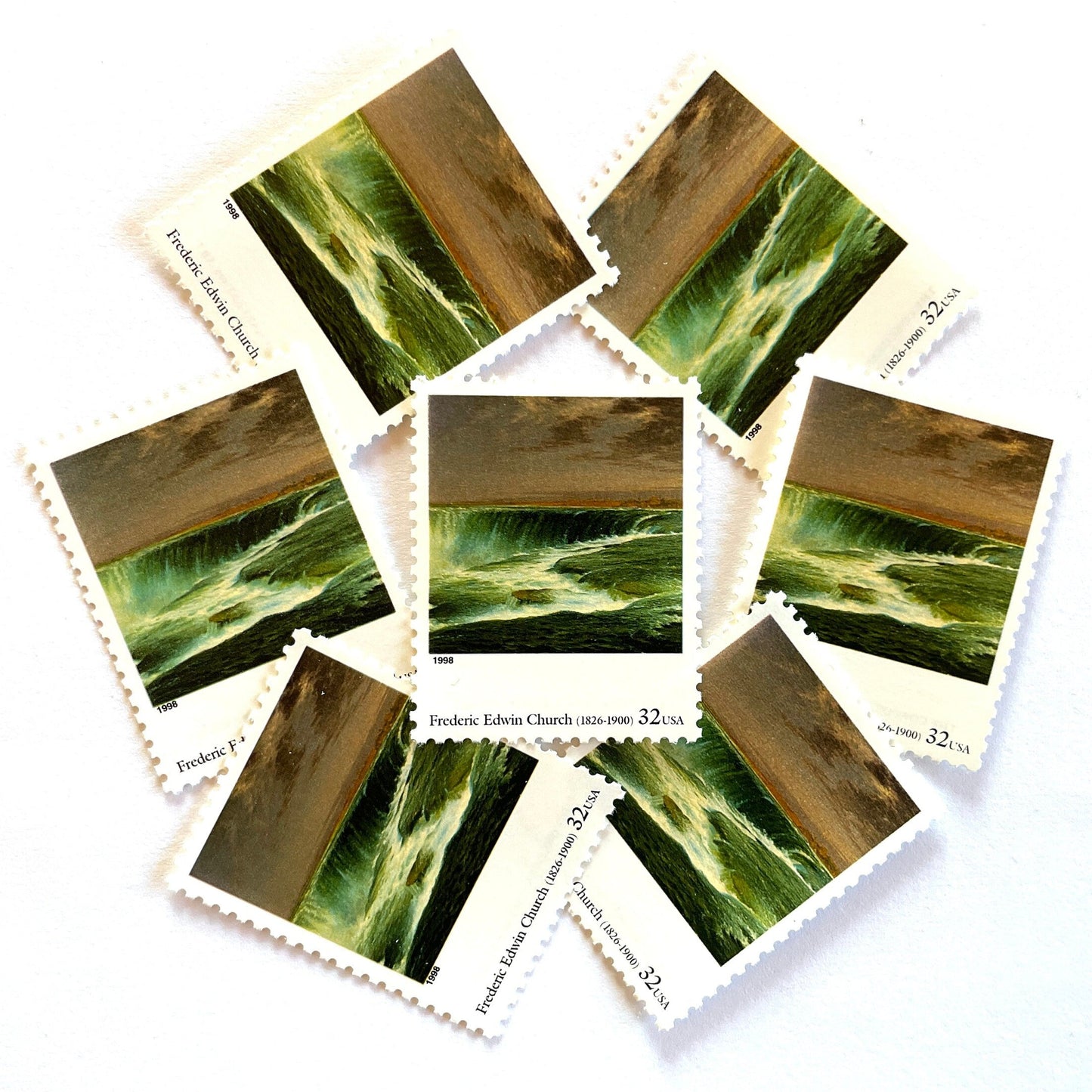 Frederic Edwin Church’s “Niagara” Postage Stamp from the 1998 Four Centuries of American Art Series. This stamp depicts the iconic landscape painting of Niagara Falls. An iconic nature theme, this stamp predominately green postage stamp depicts the waterfall that is shared by the United States and Canada and is a favorite honeymoon destination. These are vintage unused USPS postage stamps with a face value of 32 cents each. Scott number 3236N.