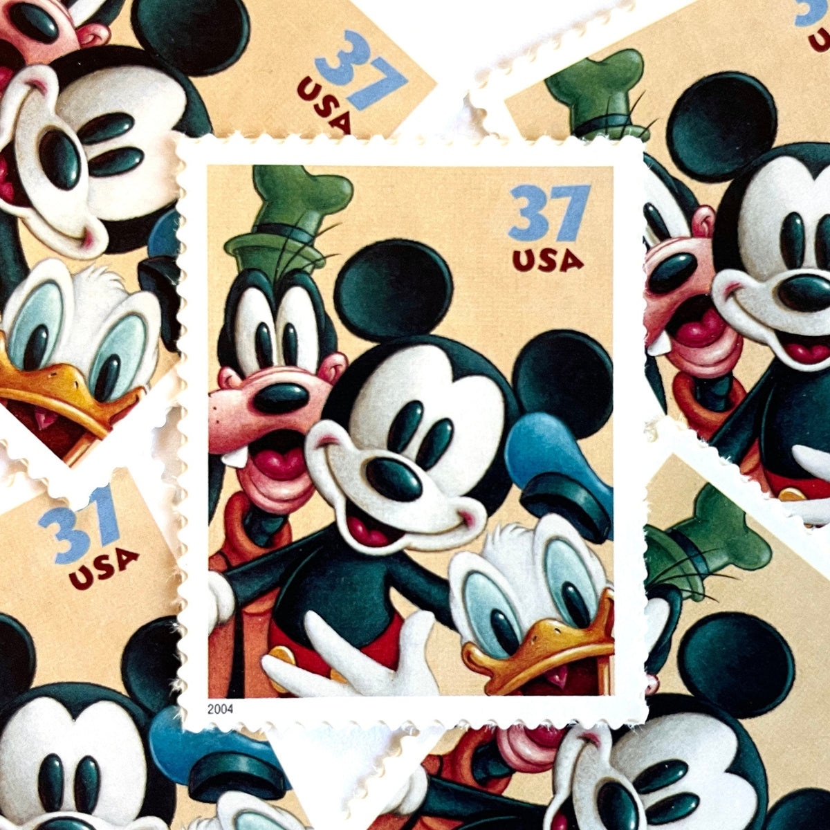 Mickey Mouse, Goofy and Donald Duck postage stamps from 2004 featuring the classic Disney friends on vintage unused 37-cent USPS postage, Scott 3865.