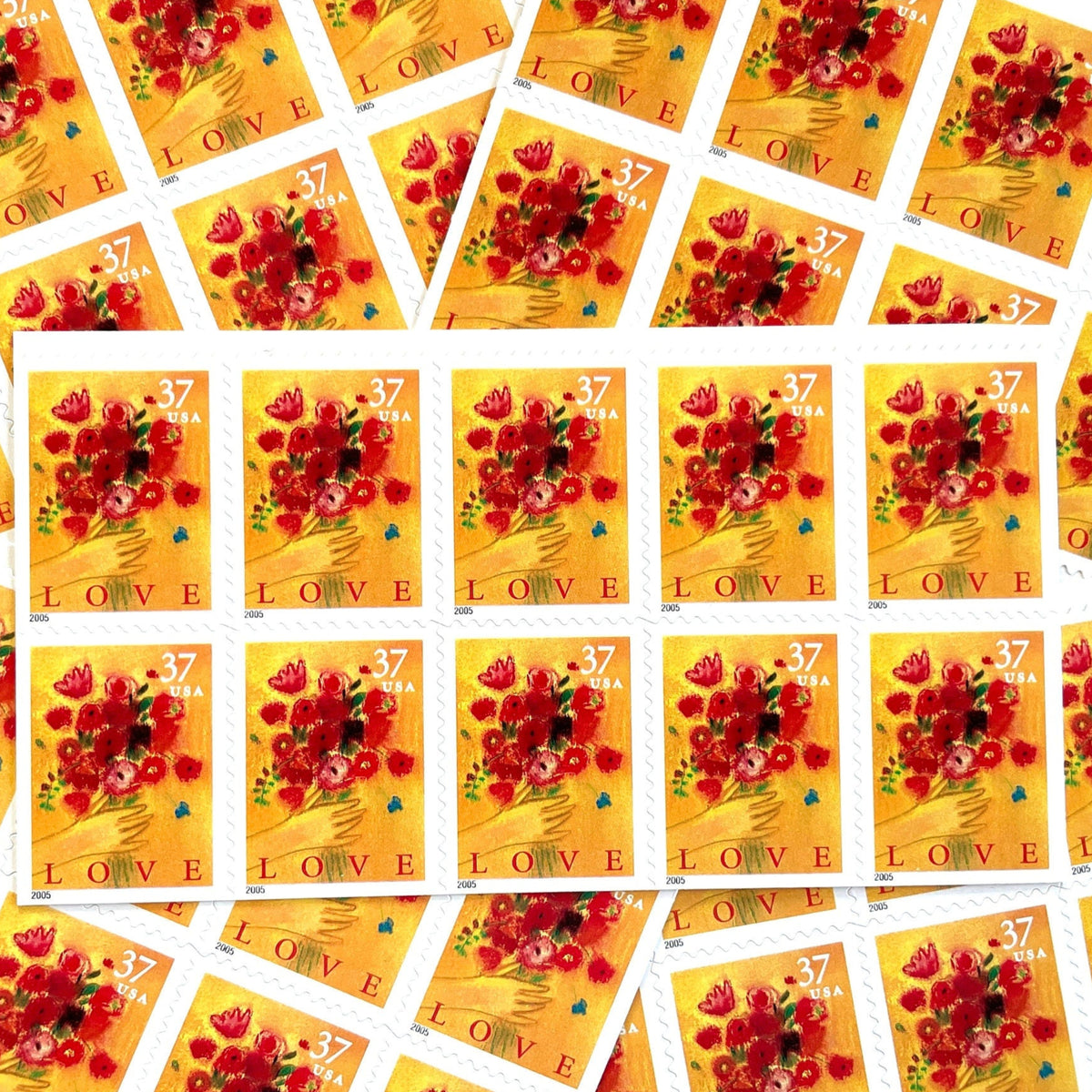 Love Bouquet postage stamps from 2005 featuring a hand offering colorful spring flowers against a yellow-gold background on vintage unused 37-cent USPS postage, Scott 3898.