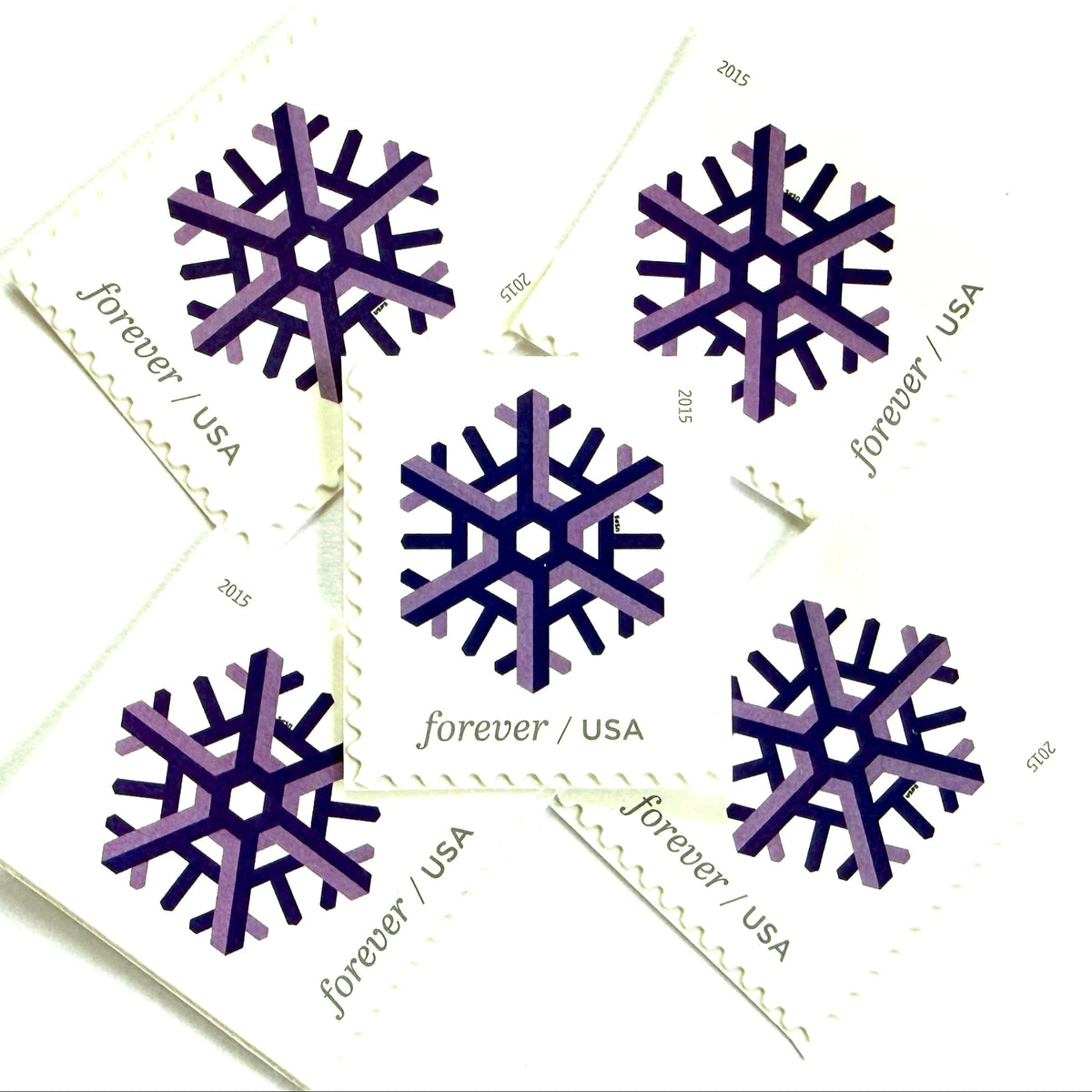Purple and lilac Geometric Snowflake postage stamps from 2015 featuring a stylized crystalline winter design on unused USPS Forever postage, Scott 5031.
