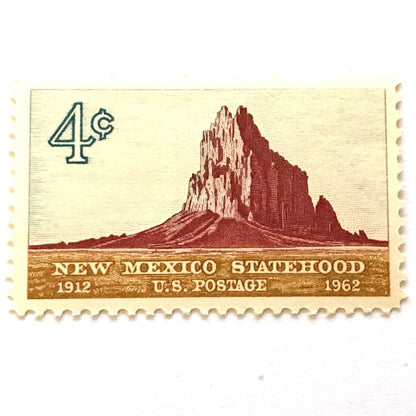 Image of New Mexico Statehood postage stamps from 1962, featuring a Southwestern desert landscape associated with Shiprock on vintage unused 4-cent USPS postage, Scott 1191.