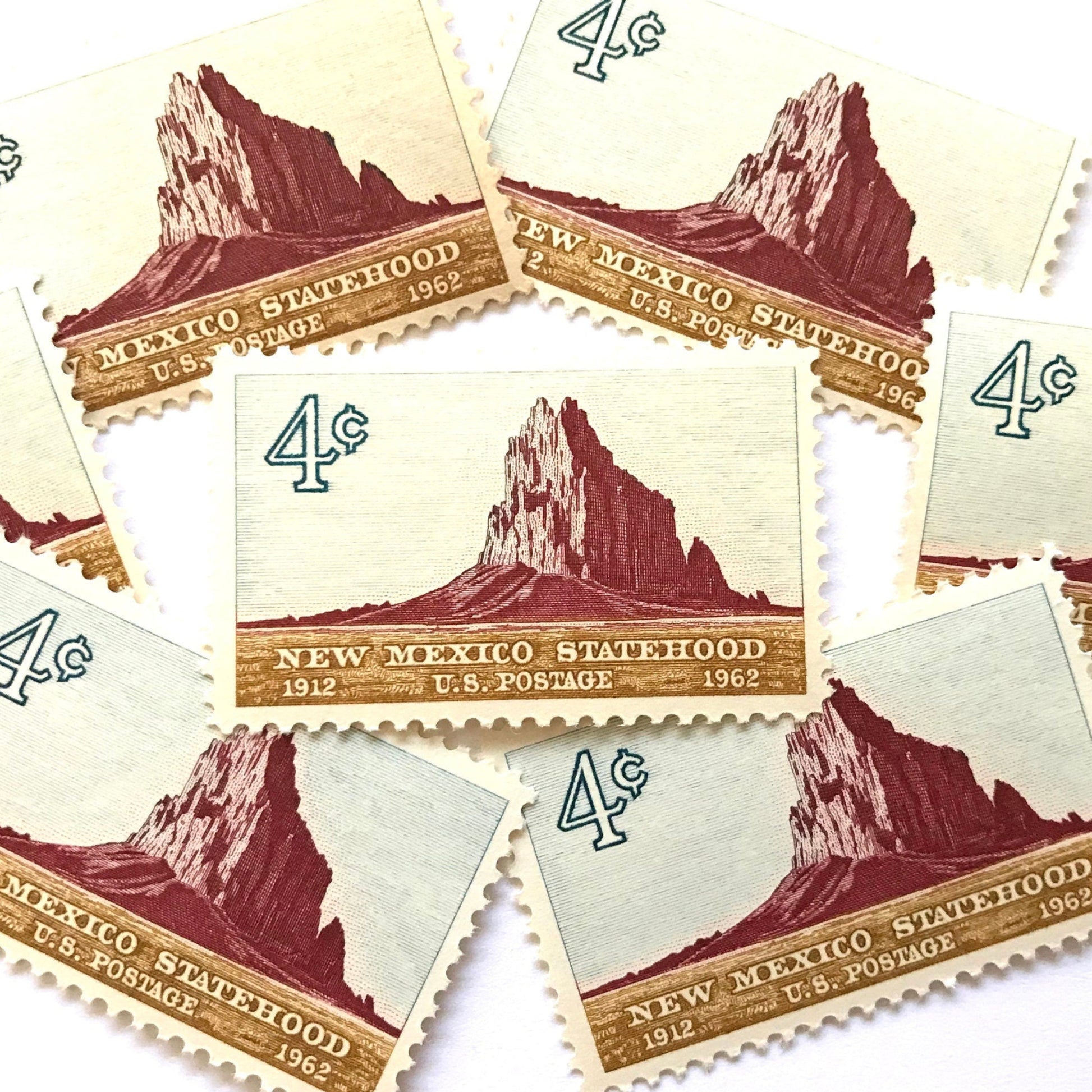 Image of New Mexico Statehood postage stamps from 1962, featuring a Southwestern desert landscape associated with Shiprock on vintage unused 4-cent USPS postage, Scott 1191.