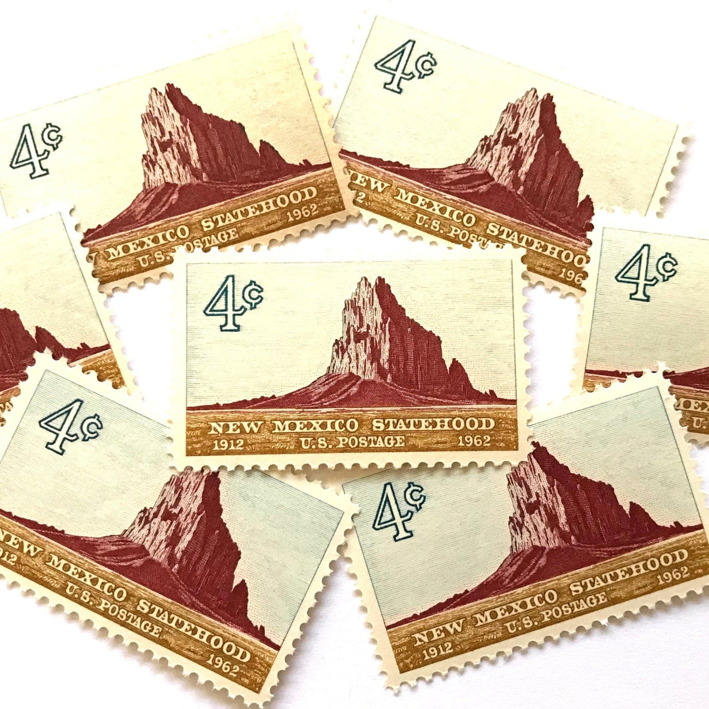 Image of New Mexico Statehood postage stamps from 1962, featuring a Southwestern desert landscape associated with Shiprock on vintage unused 4-cent USPS postage, Scott 1191.