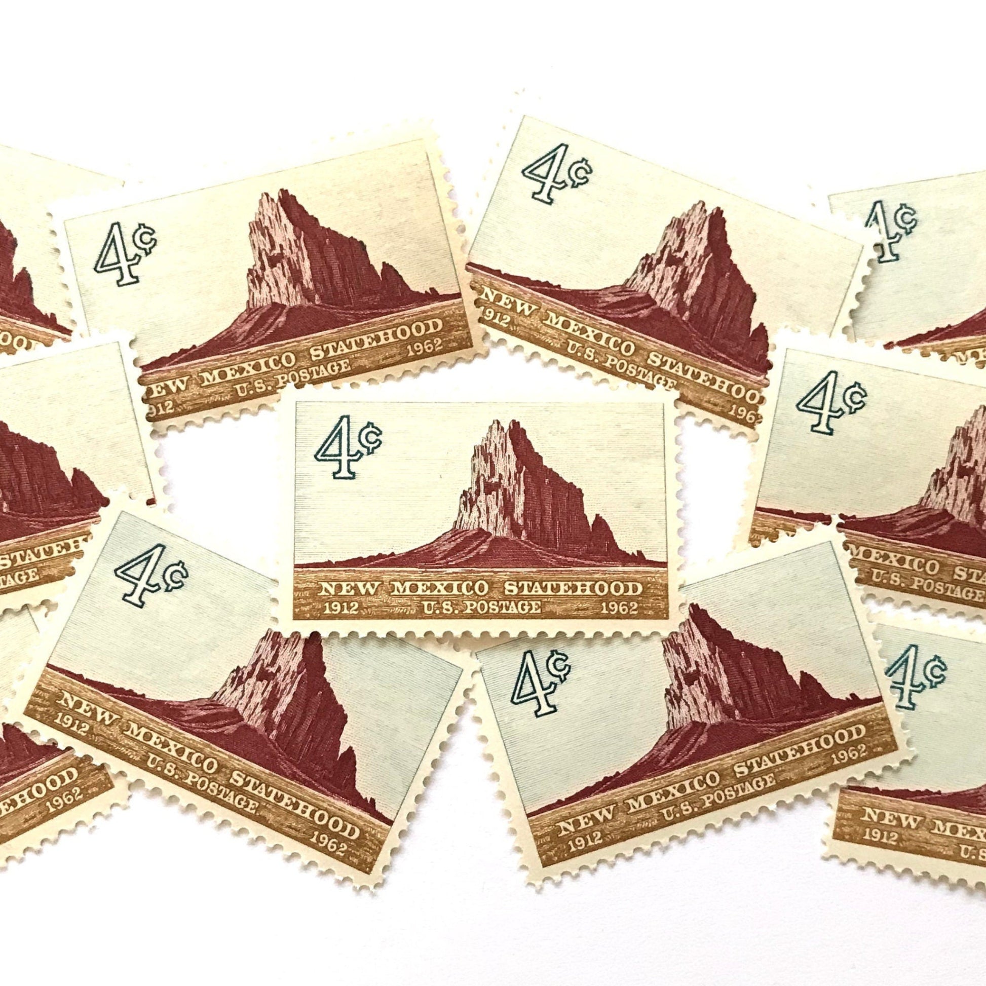 Image of New Mexico Statehood postage stamps from 1962, featuring a Southwestern desert landscape associated with Shiprock on vintage unused 4-cent USPS postage, Scott 1191.