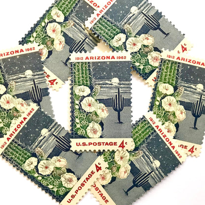 Image of Arizona Statehood postage stamps from 1962, featuring a moonlit desert scene with a saguaro cactus and cactus flower on vintage unused 4-cent USPS postage, Scott 1192.