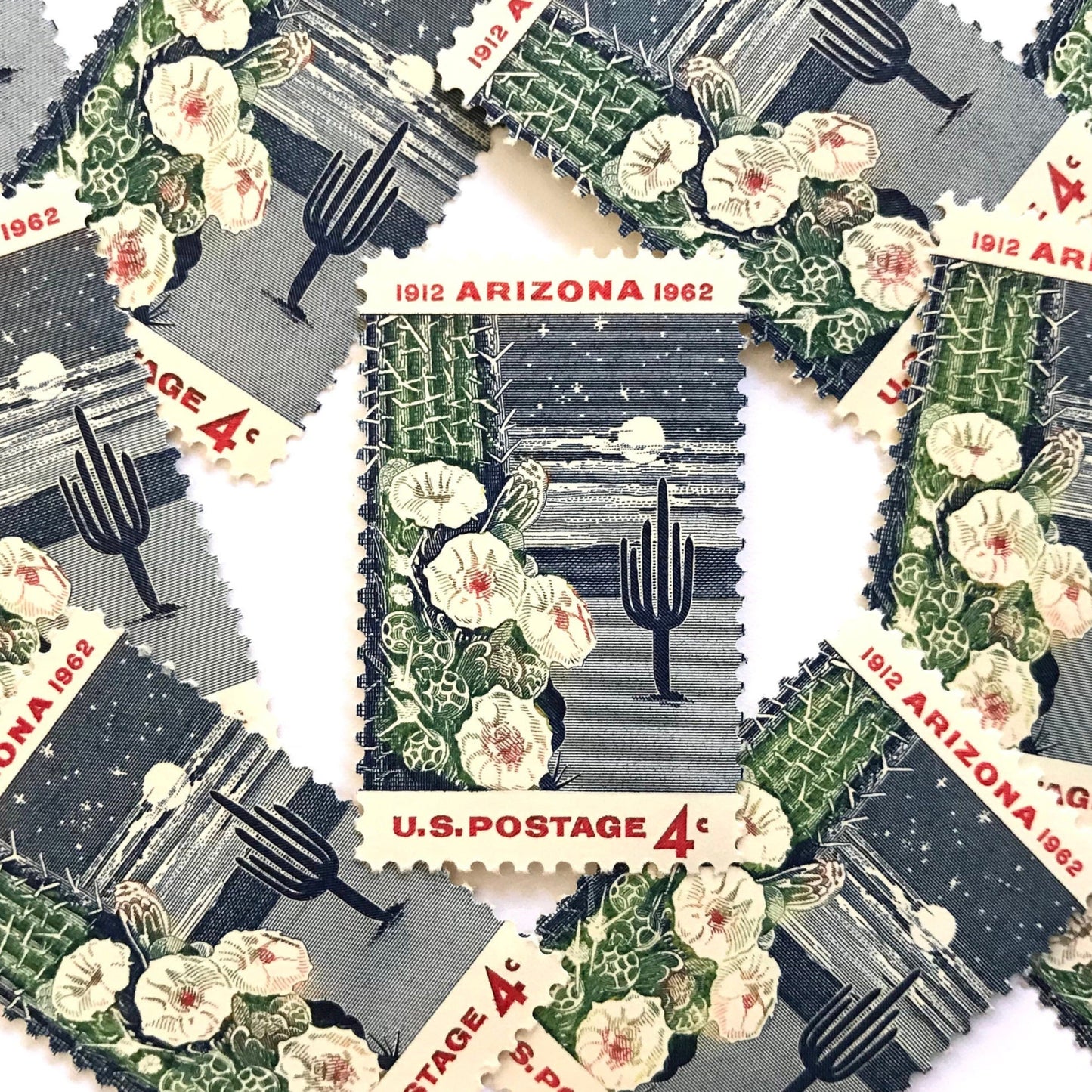 Image of Arizona Statehood postage stamps from 1962, featuring a moonlit desert scene with a saguaro cactus and cactus flower on vintage unused 4-cent USPS postage, Scott 1192.