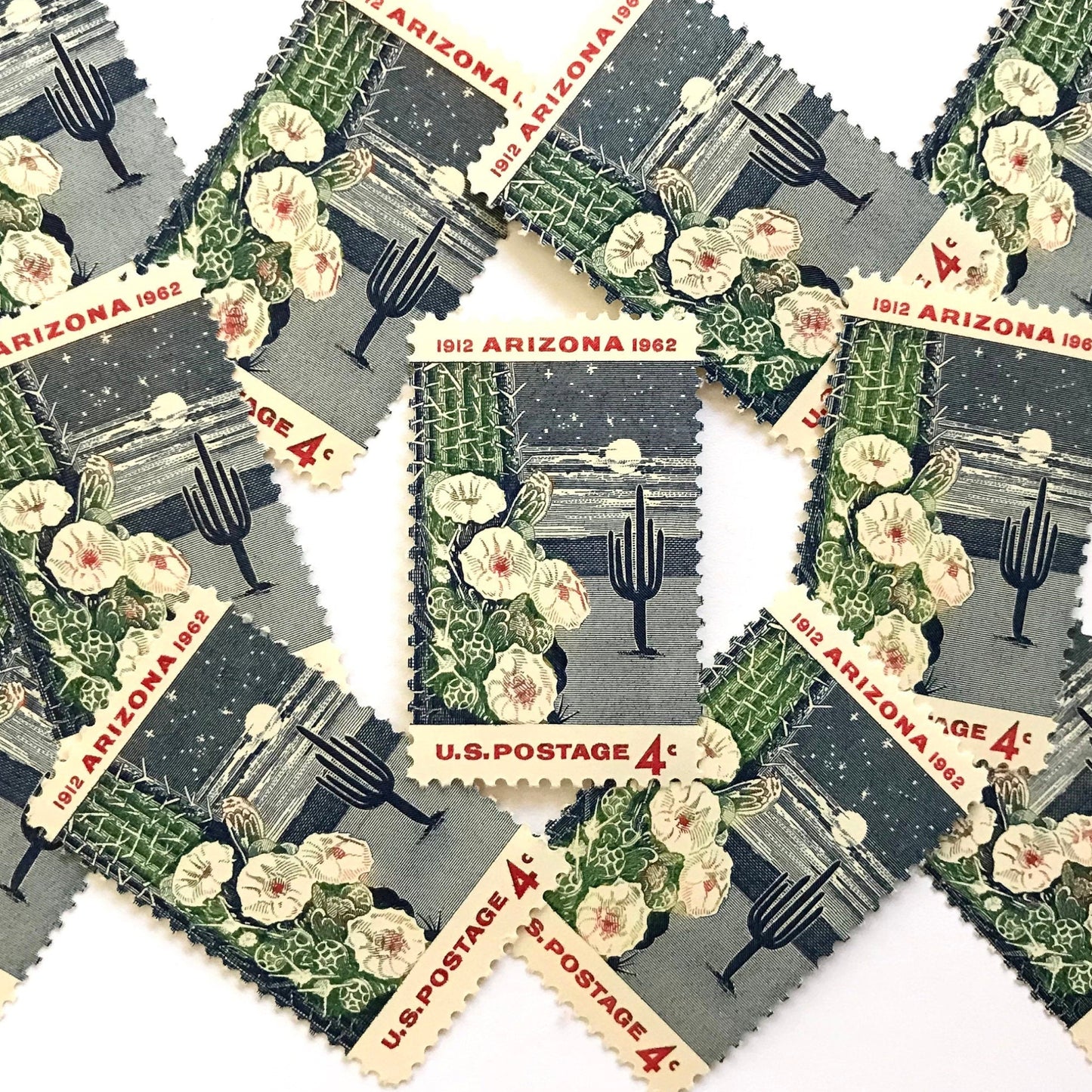 Image of Arizona Statehood postage stamps from 1962, featuring a moonlit desert scene with a saguaro cactus and cactus flower on vintage unused 4-cent USPS postage, Scott 1192.