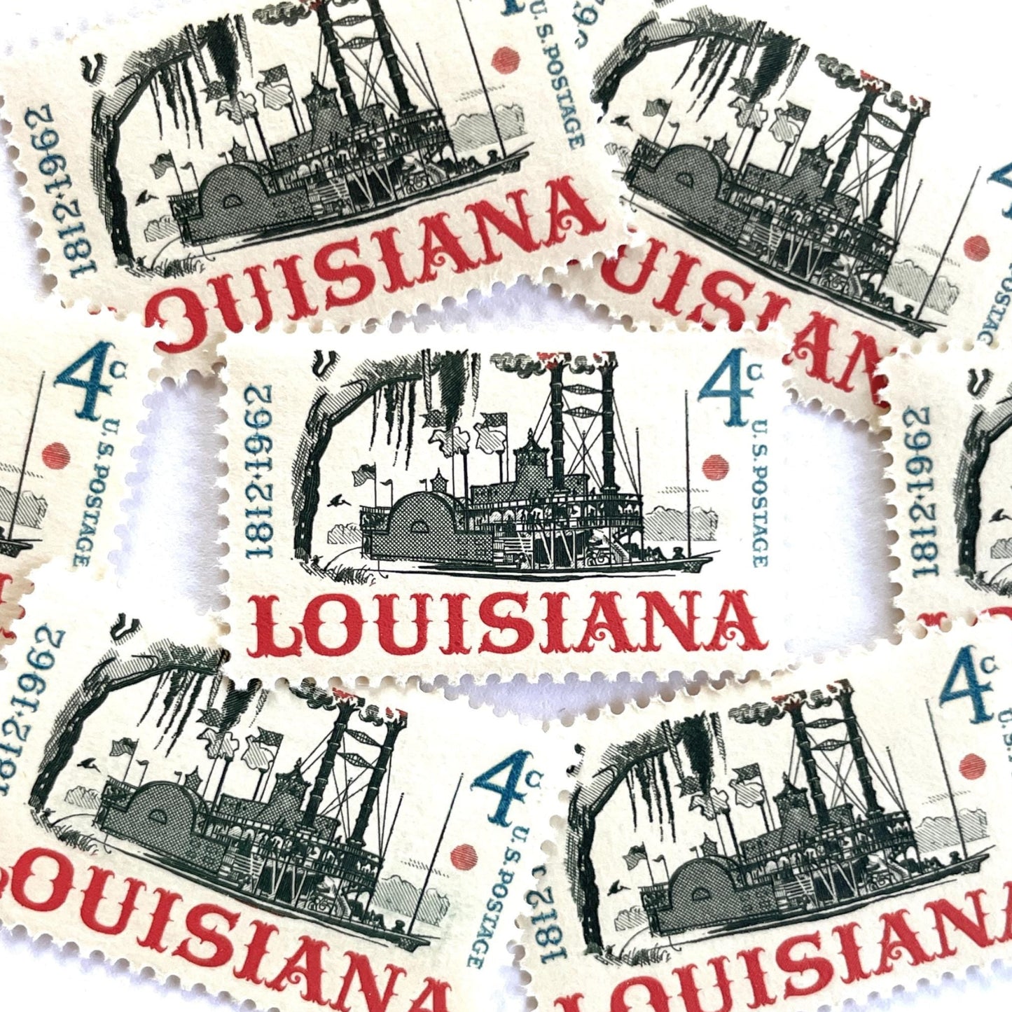 Image of Louisiana Statehood postage stamps from 1962, featuring a Mississippi River steamboat on vintage unused 4-cent USPS postage, Scott 1197.