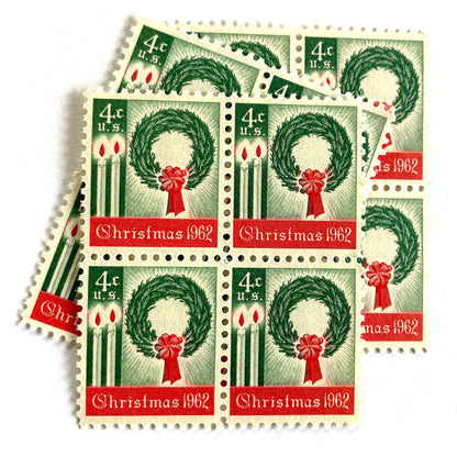 Image of 1962 Contemporary Christmas “Christmas Wreath and Candles” 4-cent stamps. Scott #1205. Stamp Themes: Wreath, Candles, Red Bow, Holidays, First U.S. Christmas Stamp. Green and red postage stamp.