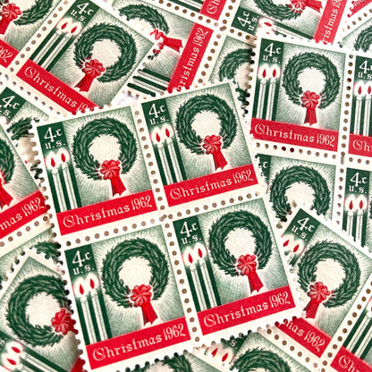 Image of 1962 Contemporary Christmas “Christmas Wreath and Candles” 4-cent stamps. Scott #1205. Stamp Themes: Wreath, Candles, Red Bow, Holidays, First U.S. Christmas Stamp. Green and red postage stamp.