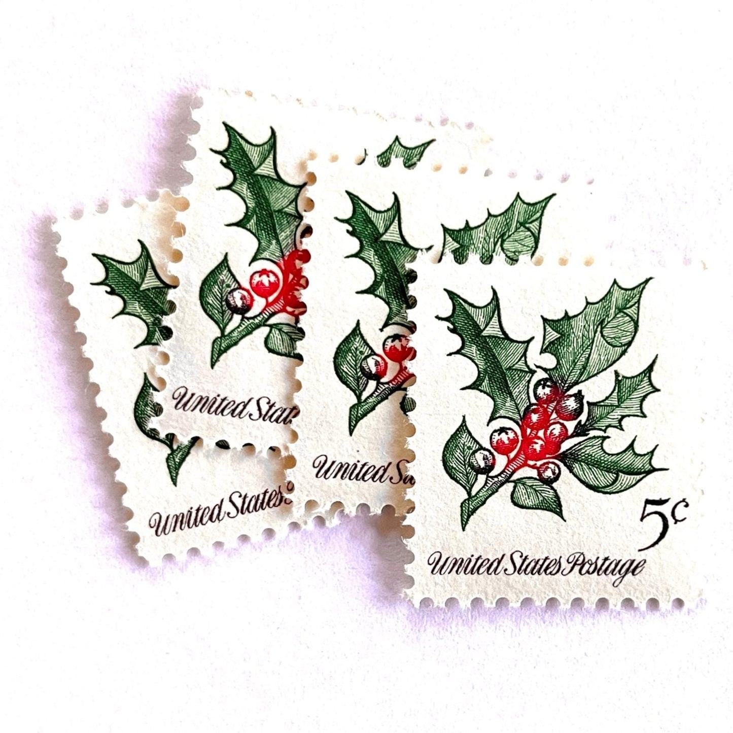 Image of 1964 Third Christmas Issue “Holly” 5-cent mail stamps. Scott #1254. Stamp Themes: Christmas Holly, Holiday Decor, Winter Flora. Green and red postage stamp.