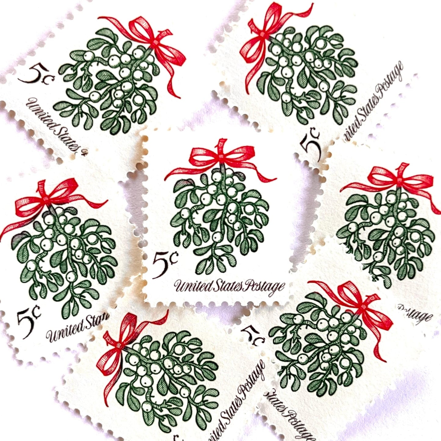 Image of 1964 Third Christmas Issue “Mistletoe” 5-cent mail stamps. Scott #1255. Stamp Themes: Christmas, Holidays, Winter Flora, Kissing, Holiday Plant, Holiday Décor. Green and red postage stamp.