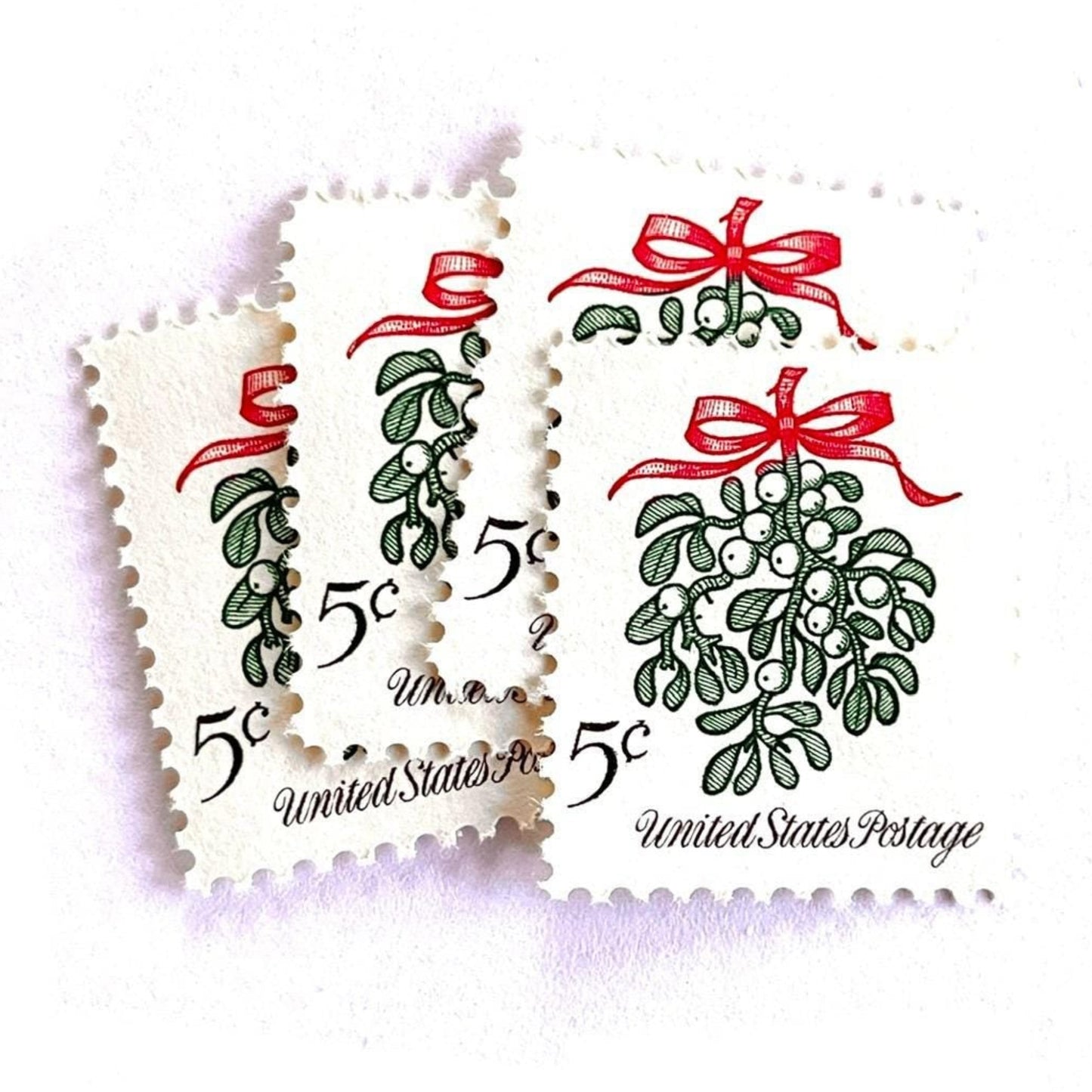 Image of 1964 Third Christmas Issue “Mistletoe” 5-cent mail stamps. Scott #1255. Stamp Themes: Christmas, Holidays, Winter Flora, Kissing, Holiday Plant, Holiday Décor. Green and red postage stamp.