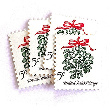 Image of 1964 Third Christmas Issue “Mistletoe” 5-cent mail stamps. Scott #1255. Stamp Themes: Christmas, Holidays, Winter Flora, Kissing, Holiday Plant, Holiday Décor. Green and red postage stamp.