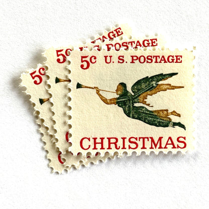 Image of 1965 “Christmas Angel” 5-cent stamps. Scott #1276. Stamp Themes: Christmas, Holidays, Angel, Weathervane, Horn, Trumpet. Green, red, white postage stamp.