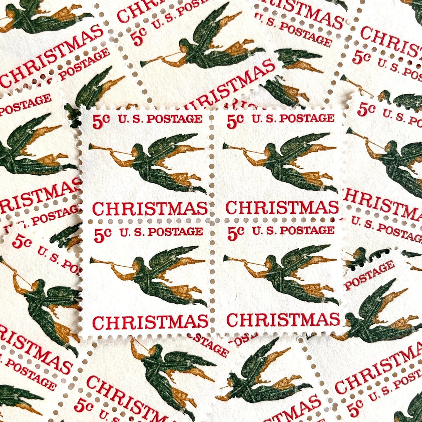 Image of 1965 “Christmas Angel” 5-cent stamps. Scott #1276. Stamp Themes: Christmas, Holidays, Angel, Weathervane, Horn, Trumpet. Green, red, white postage stamp.