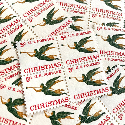 Image of 1965 “Christmas Angel” 5-cent stamps. Scott #1276. Stamp Themes: Christmas, Holidays, Angel, Weathervane, Horn, Trumpet. Green, red, white postage stamp.