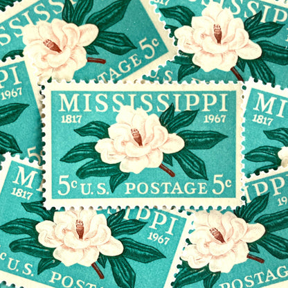Image of Mississippi Statehood postage stamps from 1967, featuring a magnolia flower design on vintage unused 5-cent USPS postage, Scott 1337.