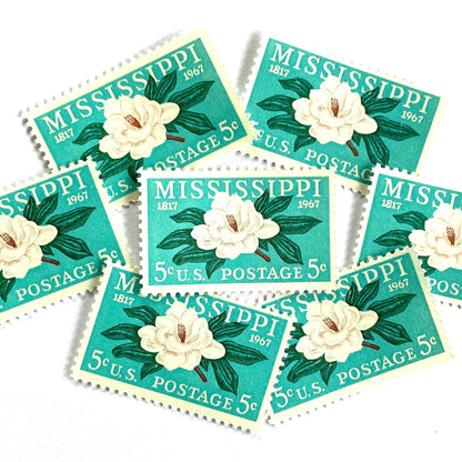 Image of Mississippi Statehood postage stamps from 1967, featuring a magnolia flower design on vintage unused 5-cent USPS postage, Scott 1337.