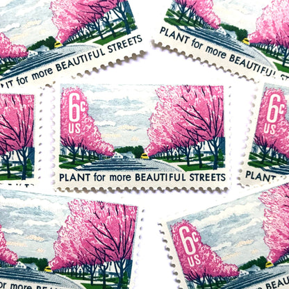 Image of 1966 Beautification of America Plant for More Beautiful Streets 6 cent stamps. Scott #1368. Stamp themes: Trees, Cherry Blossoms, Planting, Arbor Day, Streets, Neighborhood, Suburbs. Pink postage stamp.