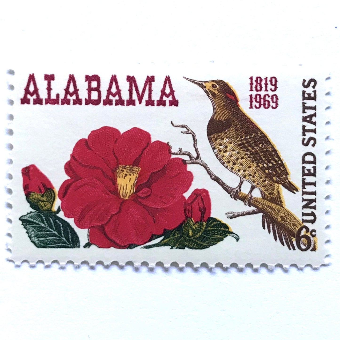 Image of Alabama Statehood postage stamps from 1969, featuring Alabama’s yellowhammer state bird and camellia state flower on vintage unused 6-cent USPS postage, Scott 1375.