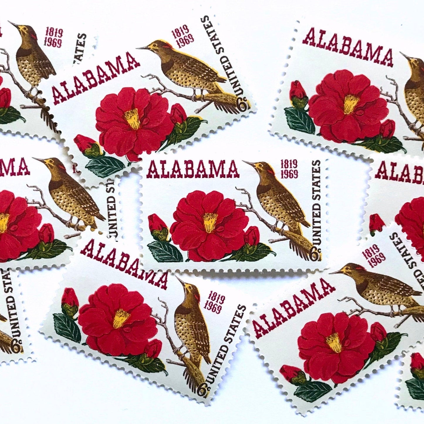Image of Alabama Statehood postage stamps from 1969, featuring Alabama’s yellowhammer state bird and camellia state flower on vintage unused 6-cent USPS postage, Scott 1375.