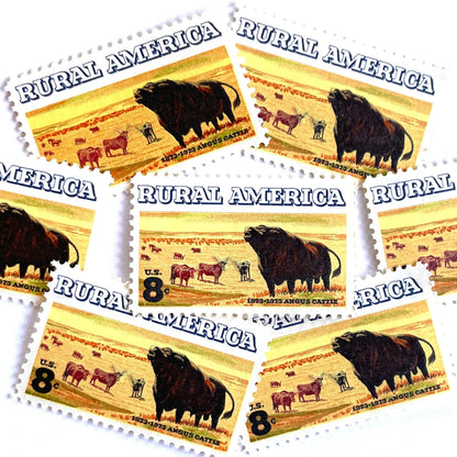 Image of 1973 Rural America Angus Cattle 8 cent stamps. Scott #1504. Stamp themes: Cattle, Livestock, Ranching, Farming, Range, Prairie, Rural America, Cowboy, Pasture Animals, Scottish Black Angus, Beef, Bull, Horns. Yellow postage stamp.