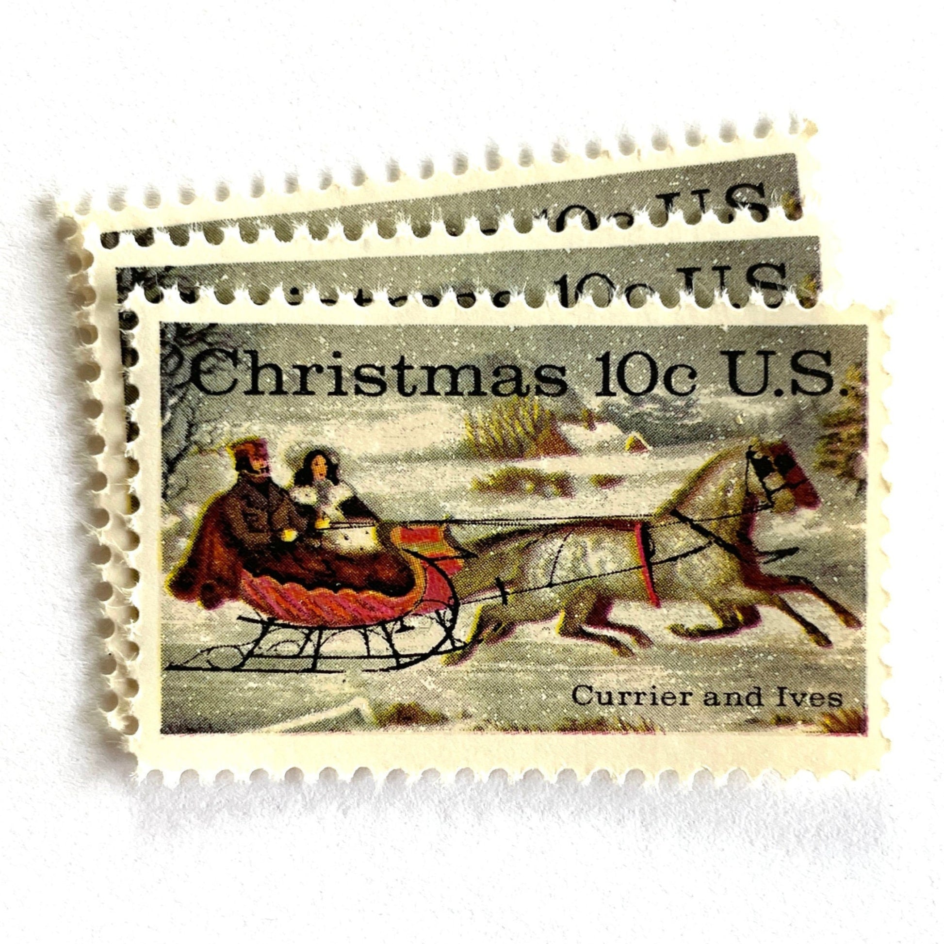 Image of 1974 Currier and Ives "Winter Road" 10 cent stamps. Scott #1551. Stamp themes: Christmas, Sleigh, Holidays, Sleigh-ride, Horse-drawn, Snow. White postage stamp.