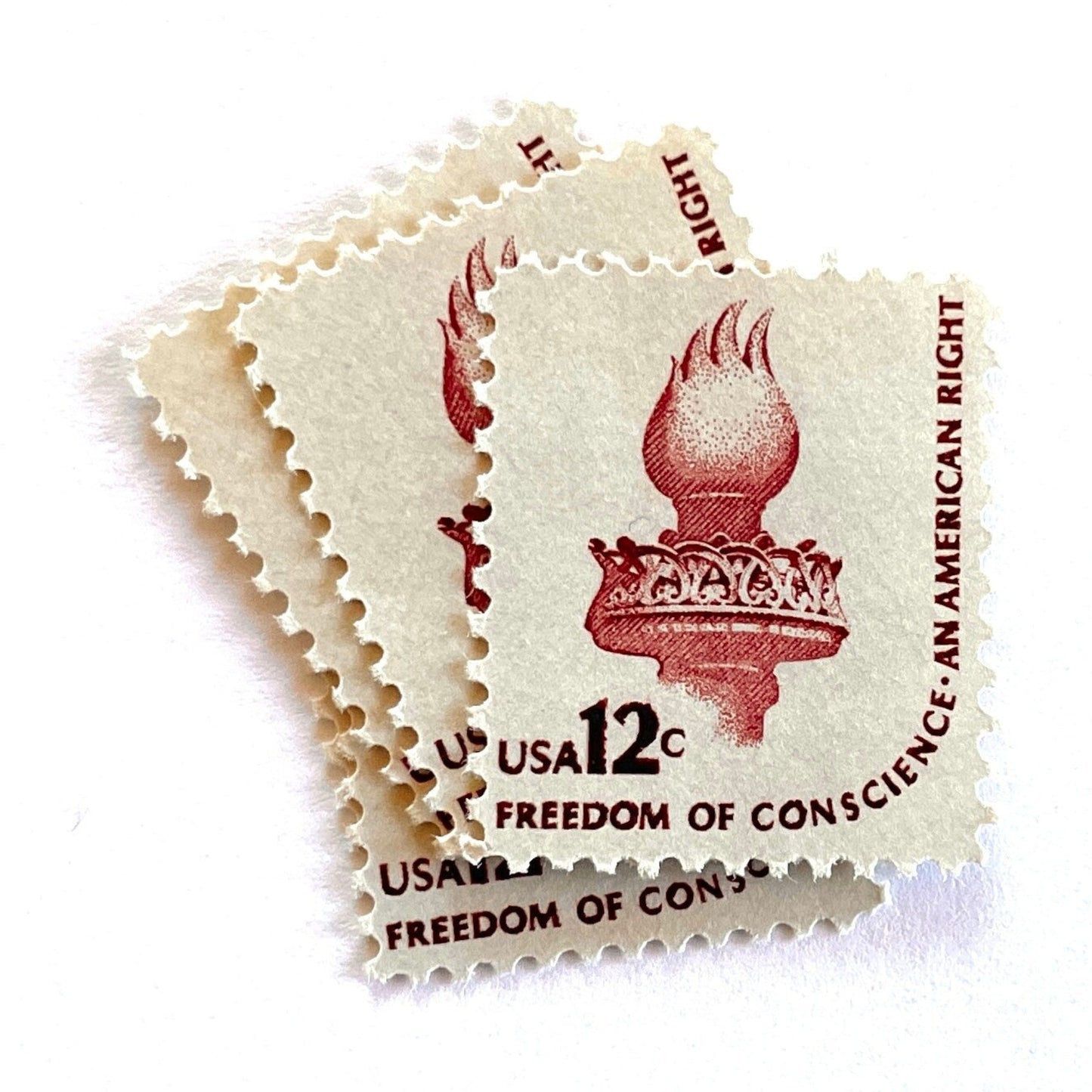 Image of 1981 Americana Series “Statue of Liberty Torch” 12-cent mail stamps. Scott #1594. Stamp Themes: Statue of Liberty, Lady Liberty, Torch, Light, NYC, New York City, Freedom of Conscience, An American Right Immigration. Red/brown postage stamp.