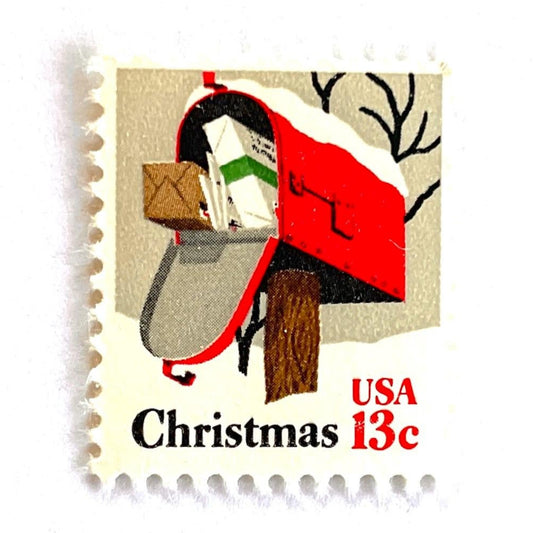Image of 1977 Contemporary Christmas “Rural Mailbox” 32-cent stamps. Scott #1730. Stamp Themes: Mailbox, Christmas Mail, Christmas Parcels, Christmas Cards, Snow, Rural America. Red and white postage stamp.