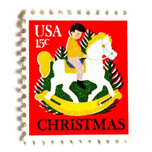 Image of 1978 Contemporary Christmas “Child on Hobby Horse” 15-cent stamps. Scott #1769. Stamp Themes: Holidays, Rocking Horse, Christmas Tree, German Folk Art. Red, green, gold postage stamp.