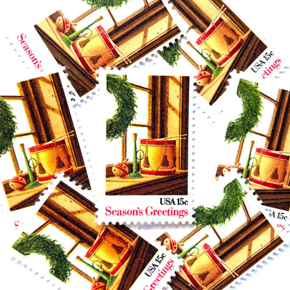 Image of 1980 Contemporary Christmas “Wreath and Toys on Window” 15-cent stamps. Scott #1843. Stamp Themes: Christmas, Holidays, Toys, Musical Instruments, Drum, Horn, Spinning Top. Multicolored postage stamp.