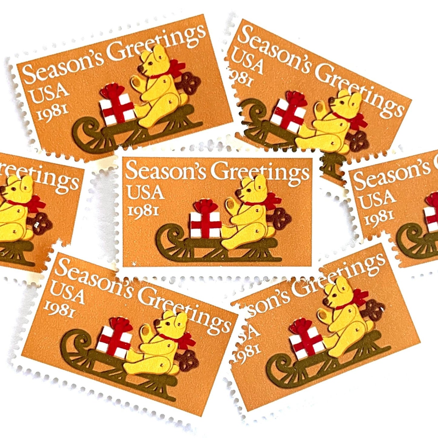 Image of 1981 Contemporary Christmas “Teddy Bear with Sleigh” 20-cent stamps. Scott #1940. Stamp Themes: Christmas, Holidays, Presents, Gifts, Sleigh, Wind-up Toy, Season’s Greetings. Gold/Beige postage stamp.