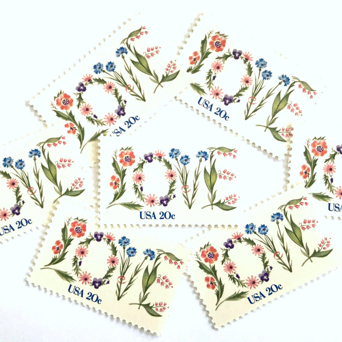 Love Flowers postage stamps from 1982 featuring the word LOVE formed with colorful flowers on vintage unused 20-cent USPS postage, Scott 1951.