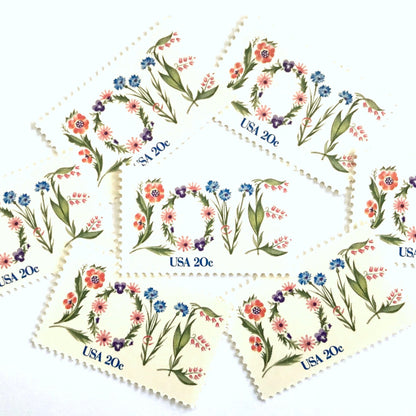 Love Flowers postage stamps from 1982 featuring the word LOVE formed with colorful flowers on vintage unused 20-cent USPS postage, Scott 1951.