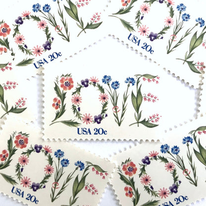 Love Flowers postage stamps from 1982 featuring the word LOVE formed with colorful flowers on vintage unused 20-cent USPS postage, Scott 1951.
