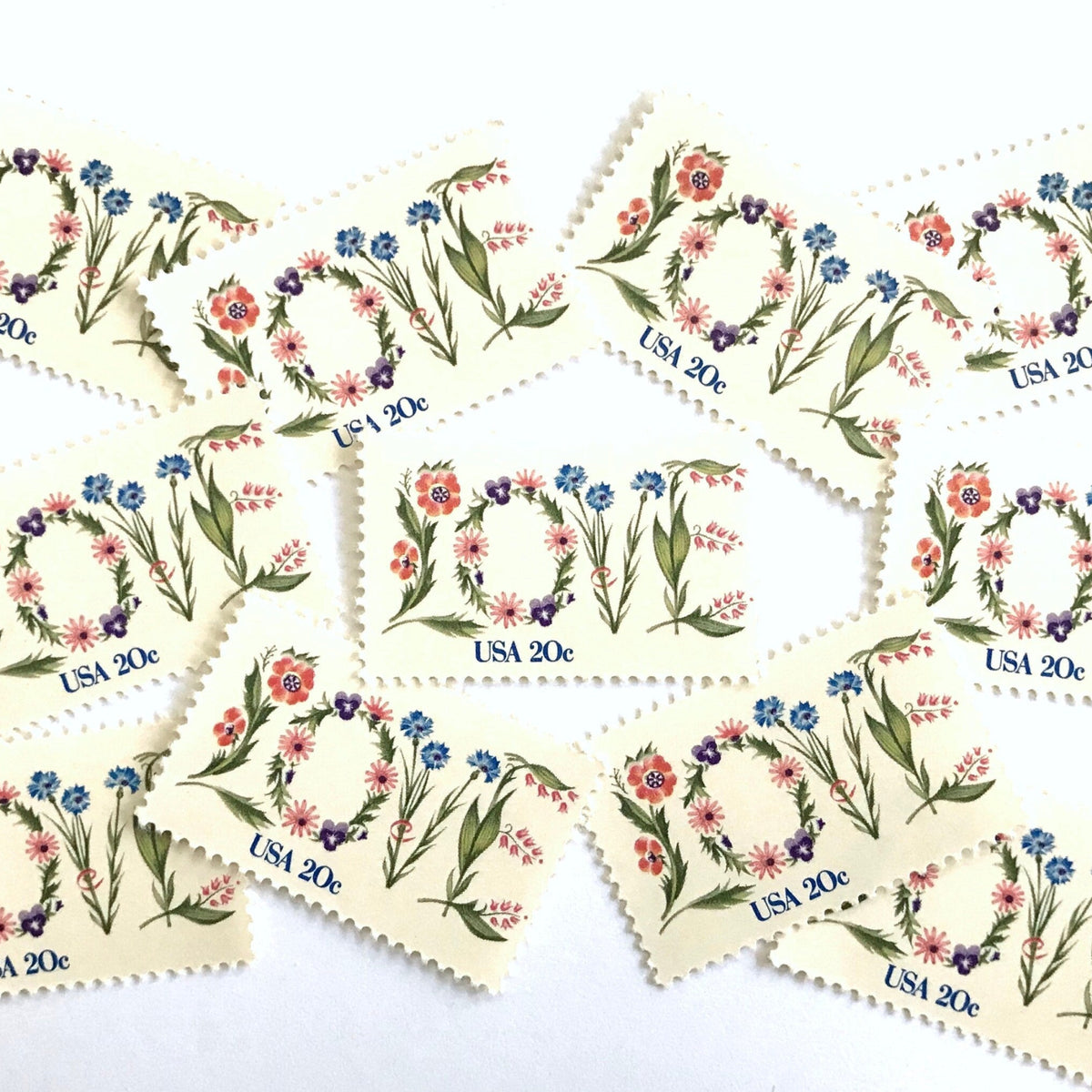 Love Flowers postage stamps from 1982 featuring the word LOVE formed with colorful flowers on vintage unused 20-cent USPS postage, Scott 1951.