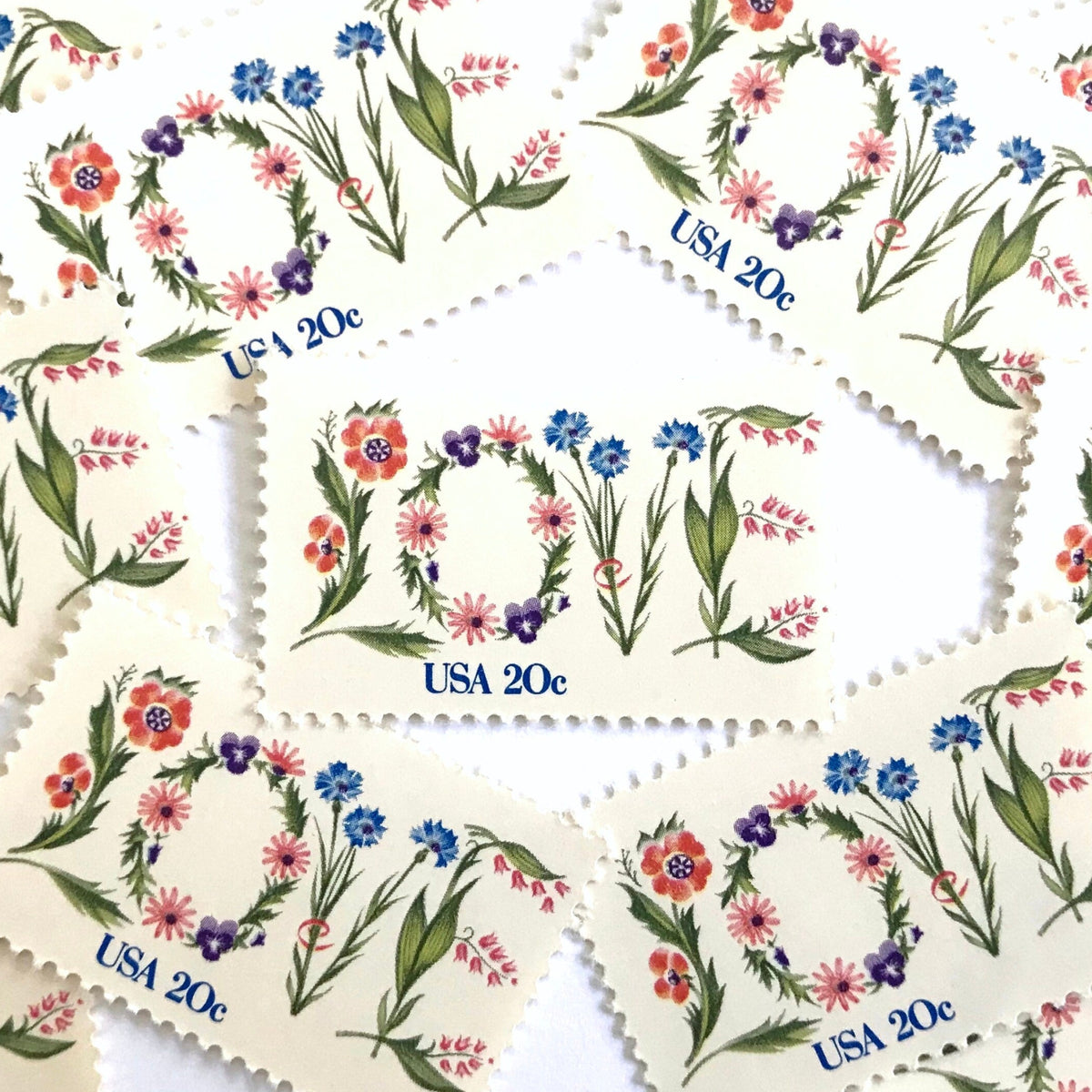 Love Flowers postage stamps from 1982 featuring the word LOVE formed with colorful flowers on vintage unused 20-cent USPS postage, Scott 1951.