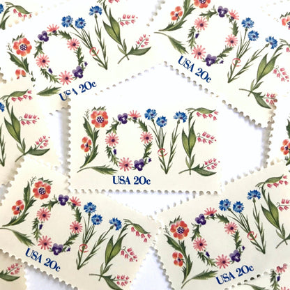 Love Flowers postage stamps from 1982 featuring the word LOVE formed with colorful flowers on vintage unused 20-cent USPS postage, Scott 1951.
