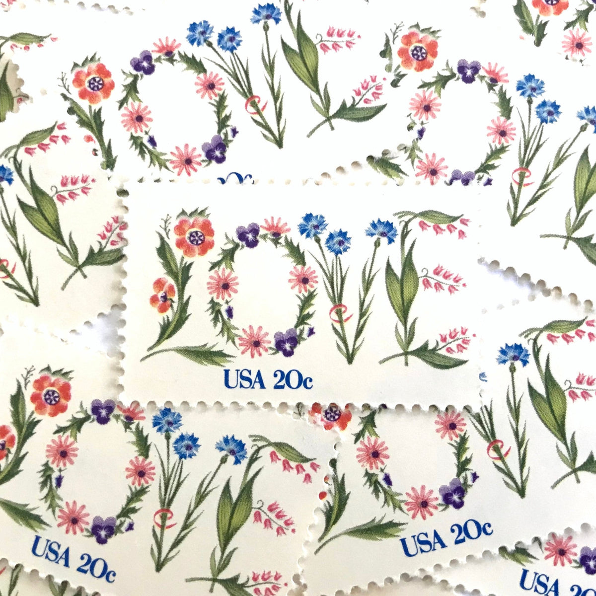 Love Flowers postage stamps from 1982 featuring the word LOVE formed with colorful flowers on vintage unused 20-cent USPS postage, Scott 1951.